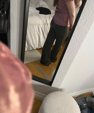 Brun-gröna utsvängda byxor - Säljer ett par mörkgröna/mer brunaktiga utsvängda byxor med mid/low midja. Byxorna har en mjuk och stretchig känsla, perfekta för en avslappnad men ändå trendig look. Passar dig som gillar en enkel men snygg stil. Säljer även toppen. 