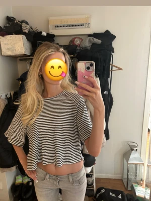 Randig croppad topp off shoulder - Säljer en svartvit randig croppad topp med lös passform och korta ärmar. Perfekt för en avslappnad stil. Lager 157 storlek S