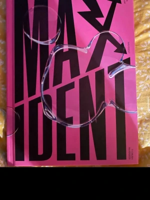 Stray Kids MAXIDENT album fotobok - Säljer en cool fotobok från Stray Kids album MAXIDENT. Boken har ett starkt rosa omslag med stora svarta bokstäver och unikt plastöverdrag. Perfekt för dig som älskar K-pop och vill ha något snyggt i bokhyllan.