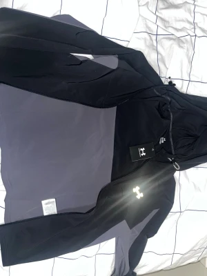 Svart & Grå Windbreaker från jd sport som är helt oanvänt och kom in nyss. Jag säljer den pga fel storlek, den kostade 1020kr men pris kan diskuteras - Snygg svart/grå windbreaker från Under Armour med dragkedja och huva. Vindjackan har gråa paneler på sidorna och en reflekterande logga på bröstet. Tillverkad i ett mjukt och stretchigt funktionsmaterial som passar perfekt till träning eller chill.