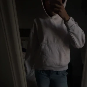 Ljusrosa hoodie från 157 - Säljer en ljusrosa hoodie från 157 med klassisk huva och magficka. Hoodien har en avslappnad passform och ribbade muddar vid ärmslut och nederkant. Perfekt för en chill och bekväm stil. Materialet känns mjukt och skönt mot huden.