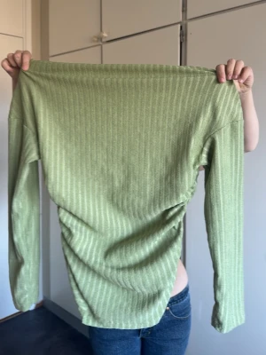 Ljusgrön ribbad långärmad topp - Snygg ljusgrön långärmad topp med ribbat mönster. Toppen har en enkel och stilren design med rund halsringning och är perfekt att matcha med jeans eller kjol. Materialet känns mjukt och stretchigt för en bekväm passform.