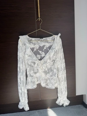 Vit spetsblus - Superfin vit blus i spets med blommigt mönster. Säljer då den inte riktigt kommer till användning. Kom privat för fler bilder eller frågor!