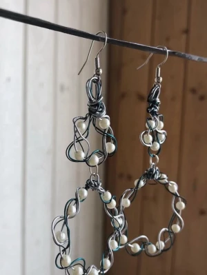 Stora örhängen med pärlor och metalltråd - Mina handgjorda örhängen i stor cirkelform, skapade av tvinnad silverfärgad och blå metalltråd dekorerade med vita pärlor. Nickelfria!  Följ min Instagram för mer <3 @veras.smycken