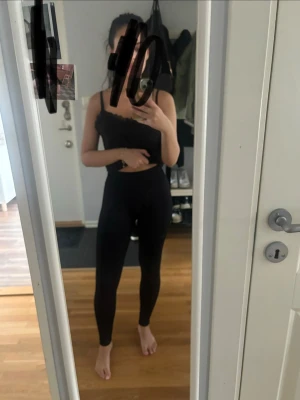 Svarta höga leggings - Säljer ett par svarta leggings med hög midja och tight passform. De är enkla och stilrena, perfekta till många olika outfits. Materialet är stretchigt och bekvämt, vilket gör dem lätta att röra sig i.