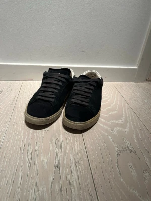 Saint Laurent skor stl 40 - Säljer dessa Saint Laurent skor i storlek 40. Skorna är i bra skick men har ett litet hack i sulan fram (se bild), men det är enkelt att limma. På insidan vid hälen är det lite slitet. Annars i väldigt gott skick.