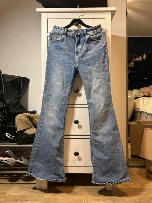 Blå utsvängda jeans med hög midja - Säljer ett par blå bootcut jeans med hög midja och utsvängda ben. Klassisk femficksmodell i mjukt denimtyg. Formar kroppen väldigt fint och mycket bekväma🫶☺️