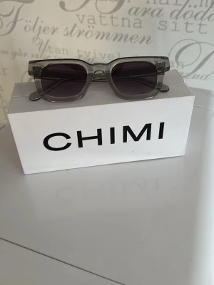 Grå chimmi 04 solglasögon - Snygga solglasögon från CHIMI med grå/silver bågar och stilren design. Perfekt accessoar för dig som vill ha en modern look. Bågarna har en klassisk form. Pris går att diskutera vid snabb affär