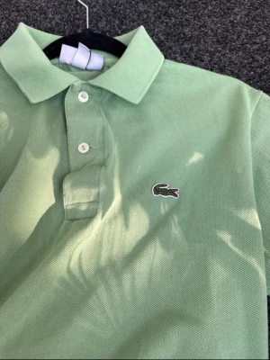 Grön pikétröja från Lacoste - Lacoste Piké Skick 9/10  Storlek S Pris kan diskuteras lite vid snabb affär Perfekt för sommaren!
