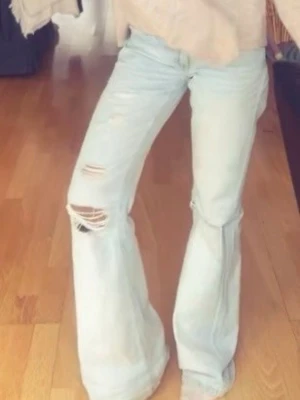 Ljusblåa bootcut jeans med slitningar - Lågmidjade, nästan helt nya jeans bara lite slitna längst ner💕 strlk 158