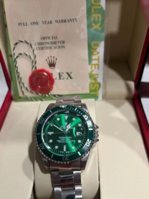 Klocka - Snygg klocka med grön urtavla och vridbar bezel. Klockan har ett robust armband i rostfritt stål och klassisk design. Perfekt för dig som gillar exklusiva accessoarer med sportig känsla.😊