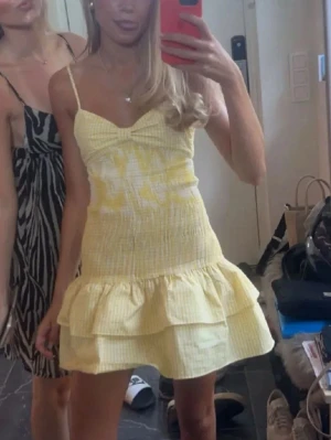 Gul volangklänning från Zara💝💝 - Söt kort klänning med smala axelband i gul- och vitrutigt mönster. Klänningen har smockad överdel, volang nedtill och en liten rosett framtill. Perfekt för varma dagar och har en lätt och luftig känsla. Köp gärna med instabox ❤️❤️
