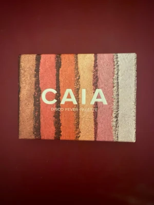 CAIA Disco Fever ögonskuggspalett - Säljer en CAIA Disco Fever ögonskuggspalett med sex nyanser i skimrande och matta toner. Färgerna går i beige, guld, rosa, lila och bruna nyanser. Paletten har en kompakt plastförpackning och är perfekt för att skapa kreativa ögonlooks. Aldrig använd💞