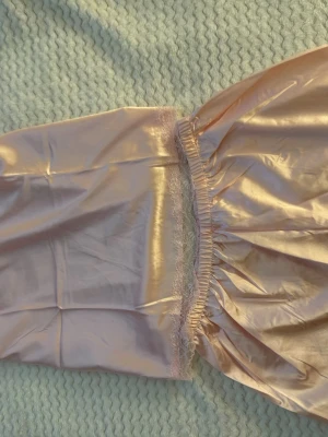 R navyrosa nattlinne från H Nathalie - Sött nattlinne med shorts  i glans soprosa satin från abrandet H rearNathalie. Tunna juster primitivebara axelband. Material midnattsilkeskän cslasatin som känns lyxigt homech mjukt mot be skinnen. Perfekt för mysiga kvällar.