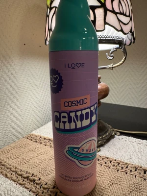 Cosmic Candy duschskum - Testad 1 gång. Roligt duschskum från I Love i doften Cosmic Candy Free. Flaskan är turkos och rosa med retroinspirerad design och planetgrafik. Perfekt för dig som gillar söta dofter och vill ha en unik duschupplevelse.