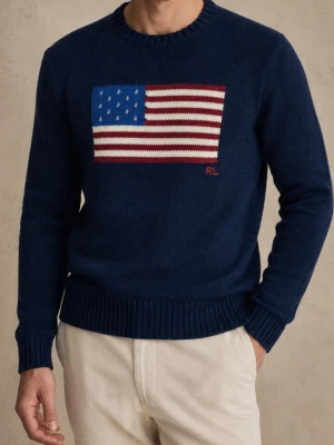 Mörkblå stickad tröja Polo Ralph Lauren - Mörkblå stickad tröja från Polo Ralph Lauren med amerikansk flagga i rött, vitt och blått på bröstet. RL-broderi i rött. Klassisk rund halsringning och ribbstickade muddar. Perfekt för dig som gillar ikoniska detaljer och tidlös stil.