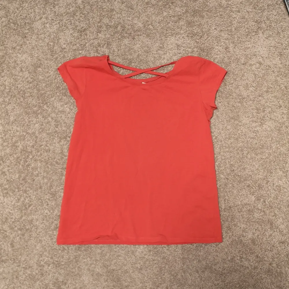 Jättefin T-shirt i en korallrosa färg. Har rors vid ryggen och är i nyskick. Storlek 170 från Linde kids. T-shirts.