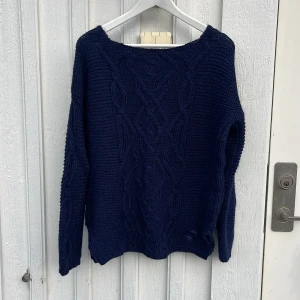 Marinblå stickad tröja  - Marinblåstickad tröja i samma modell som den andra vita Bandelid tröjan som jag säljer. Perfekt om du vill ha en Rory Gilmore liknande tröja med en twist. Perfekt inför vintern och hösten!