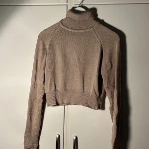 Stickad polotröja  - Brun stickad polotröja från NA-KD. Säljer pga att den inte kommer till användning. 