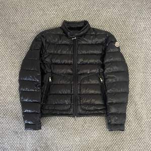 Säljer nu min fräscha Moncler Acorus jacka. Jackan är i superfint skick 9/10, minimalt pinhole på ärmen (bild 3). Jackan är i storlek 2 vilket motsvarar storlek S. Självklart autentisk (qrkod & legitcheck). Hör gärna av dig vid frågor eller fler bilder :)