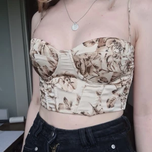 Korsett - Korsett-topp i fin färg och fint mönster. Den har justerbara axelband och knyts baktill så storleken kan anpassas. Sitter då helt perfekt och lyfter ens 🍒👀 Nyskick då den användes ca 3 ggr
