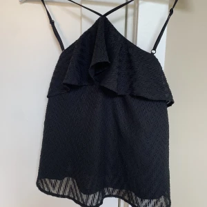 Topp med volang - Super fin topp med volang och korsning där fram!💕👌🏻