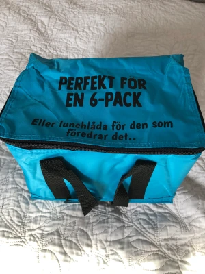 Liten kylväska med kul text  - Liten kylväska, med kul text. Aldrig använd 