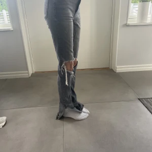 jeans zara - assnygga jeans från zara, slits vid fötterna och hål i knäna. högmidjade. säljer då dom är för långa för mig (ca 170cm) finns vissa defekter, man ser på 3e bilden, dem är även lite slitna längst ner men inget som märks. Kontakta vid frågor/fler bilder 💘💘💘