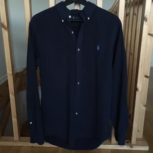 Ralph Lauren skjorta - Tja! Säljer nu min mörkblå Ralph Lauren skjorta. Skick:9/10. Storlek: M, Classic fit. Kontakta mig för fler bilder och infon!