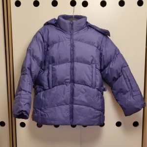 Purple Puffer Jacket  - Selling a super cozy purple puffer jacket from Wimex Winter Wear. It is perfect for cold winter days with its warm lining. The jacket has a zip at the front and long sleeves. The material is a blend of polyester and cotton.