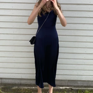 Marinblå klänning - marinblå klänning i storlek xs med öppen rygg, banden på axlarna är justerbara