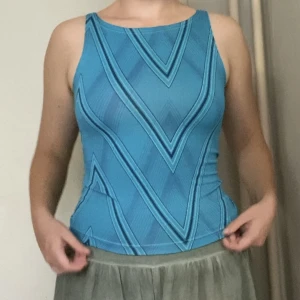 y2k topp - Snygg y2k-topp köpt second hand i Ljubljana! Säljer för att det inte riktigt är min stil. Svårt att fånga på bild men tyget är lite glittrigt! 😍Står att det är storlek Onesize och den är stretchig, men skulle säga att den sitter typ som S/M. 