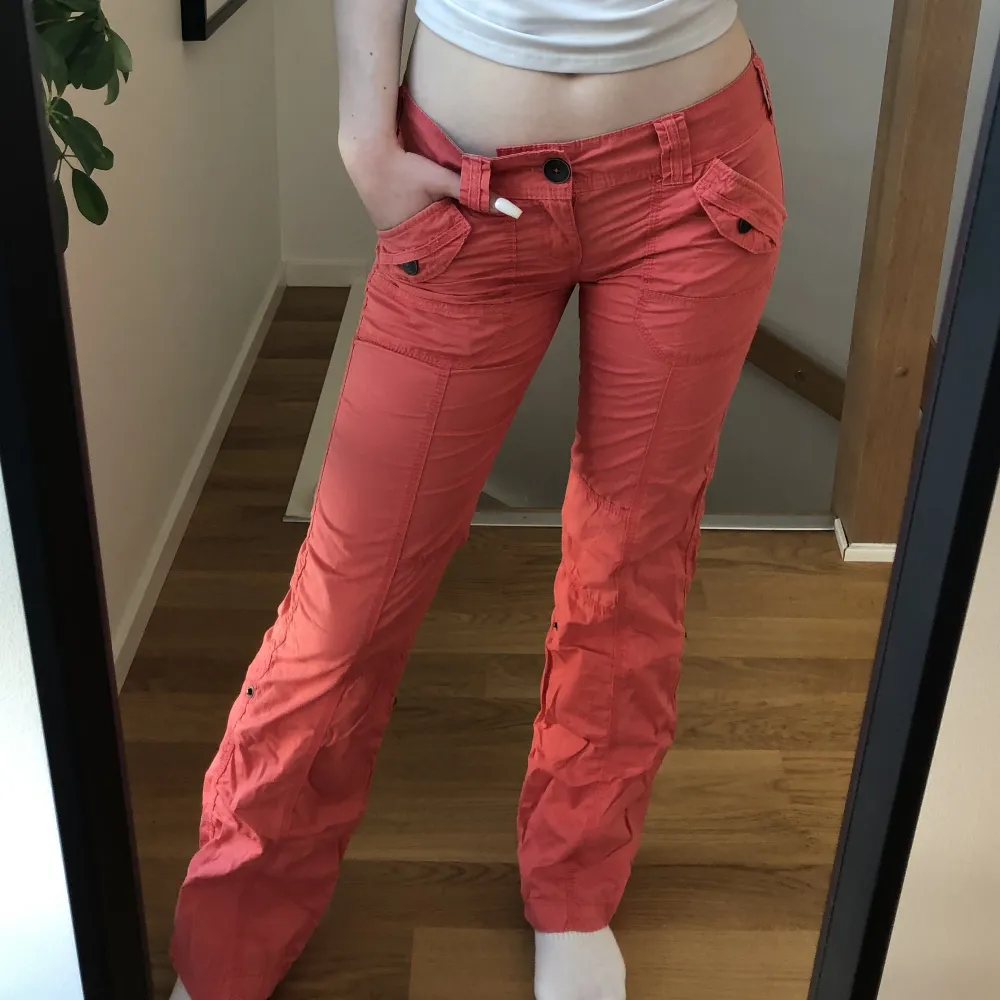 Säljer de här lågmidjade, coola, orange/röda ”cargo” byxorna från secondhand. Jättebra skick då jag använt de bara en gång, säljer just därför. . Jeans & Byxor.