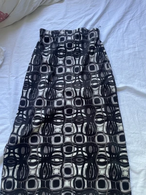 Kjol - Säljer denna långkjol i barnstorlek med mönster i svart, grå och vit! Kjolen är i bra skick.