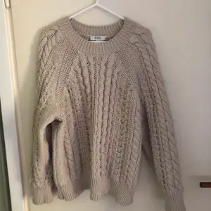 White cable-knitted sweater
