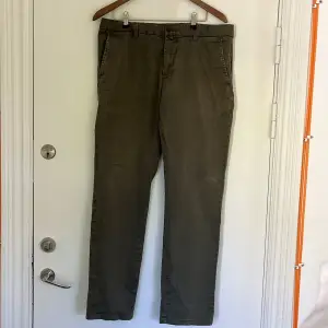 Olive-coloured chinos.  Model: Low waist, Narrow Fit