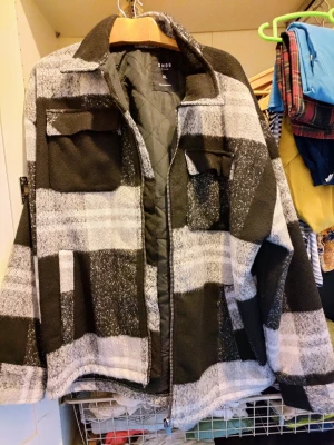 Two winter jackets - The brown jacket work thrice. The black and white checkered sweat-shirt cum jacket new not worn.