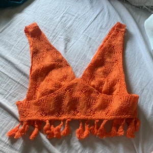 Orange topp - En orange topp med spets och små tofsar längst ner med en dragkedja. Aldrig använt då den inte passade