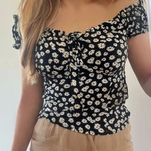 Off shoulder top - 🖤Tunt bomullstyg med vita blommor på, dragkedja på sidan för av och påtagning.  🤍stlk. XS  🖤Fint skick! Använd ett fåtal gånger.