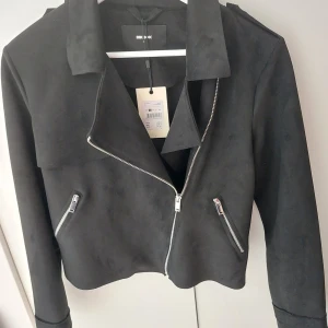 Bikerjacka i mocka. - Oanvänd dam bikerjacka i mocka. Storlek S. Köpt på Bik Bok för 599kr.  Från rök/djurfritt hem.  