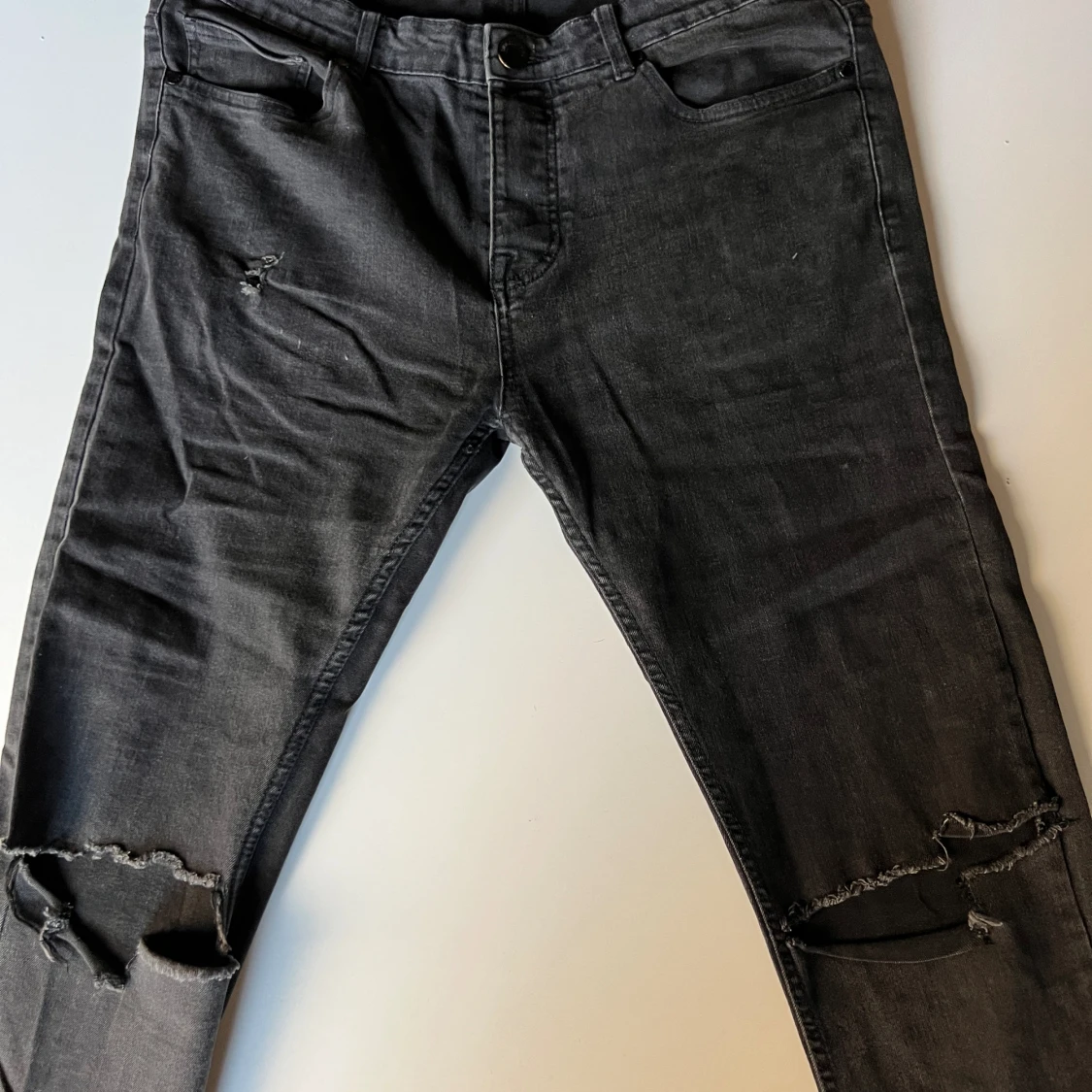 Svarta jeans med hål