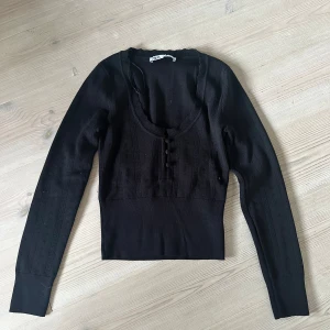 Långärmad topp från Zara - Säljer denna fina stickade toppen med knäppning från Zara! Den är helt oanvänd och lappar finns kvar. Storlek S. 