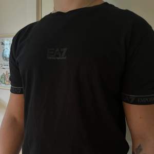 En snygg svart t-shirt från Armani! Perfekt nu till sommaren ☀️i superfint skick! 10/10 🤝🏽 Modellen på bilden har strl M och är 173 lång