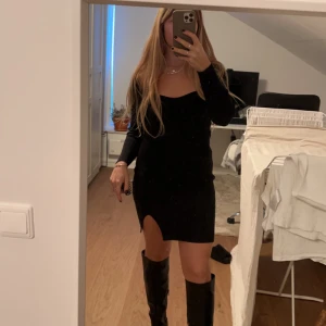 Svart klänning Chiquelle - Svart ribbad mjuk klänning från Chiquelle. Slits på sidan. One size 