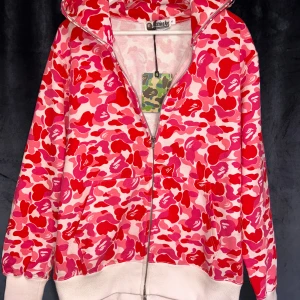 Bape zip - Säljer min extrem fina rosa bape hoodie som vekrligen får en att sticka ut från mängden. Storlek S. Tags och påse medföljer. Vid frågor så är det bara att kontakta.