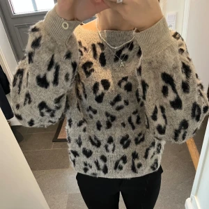 Stickad grå tröja med leopardmönster - Stickad grå tröja från River Island med leopardmönster. Står storlek 10 och passar som en S/M. Fint skick! Använd gärna köp nu! 