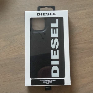 Diesel iPhone skal 11 PRO MAX  - Diesel iPhone 11 PRO MAX skal. ”Moulded snap case”. Skitsnyggt skal med Diesel Logo!   Fick i julklapp men är fel modell, därför har jag öppnat för att se om den gick på min mobil. Men skalet är aldrig använt förutom när jag testa storleksskilnaden! 