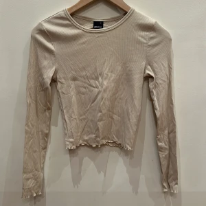 Crop top i beige från ginatricot  - Säljer en crop top från ginatricot med öppen rygg i storlek S.