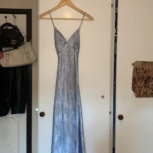 Silkesklänning - Ljusblå silkesklänning med blommor inmönstrade. Skicket är som nytt🎀 Skriv om fler frågor eller bilder! 