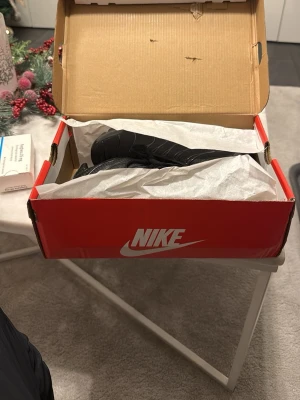 Nike Air tn svarta sneakers med grönt - Nike Air Max sneakers i svart med gröna detaljer och synlig Air-sula. Snygg mesh och syntet på ovandelen, med snörning och rund tå. Grönt swoosh på sidan och gröna accenter på sulan. Kommer i originalkartong. Helt nya fuck dem i present i fel storlek